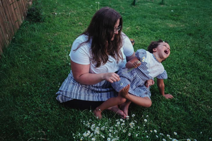 Liz playing with her daughter in the backyard