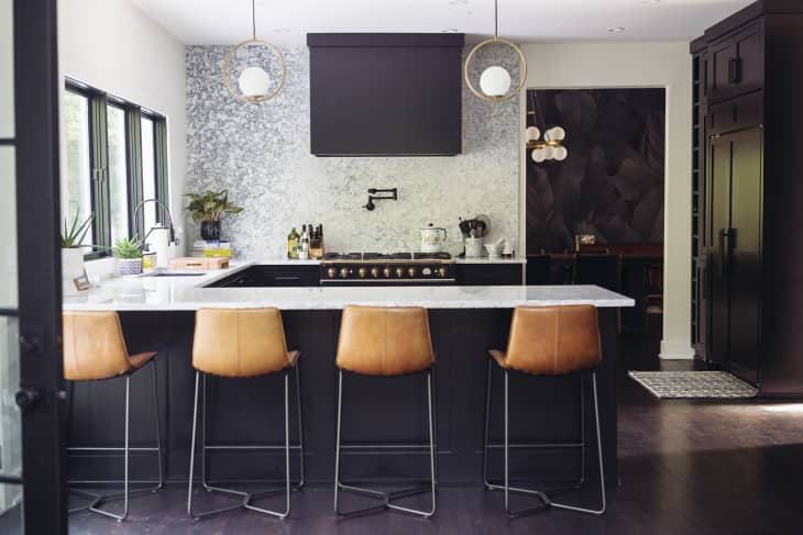 view of Kate's kitchen with marble countertops and leather bar stools
