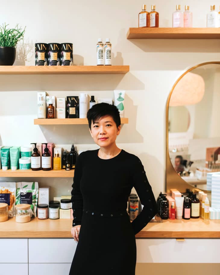 Diana Wang in front of wooden shelves on product