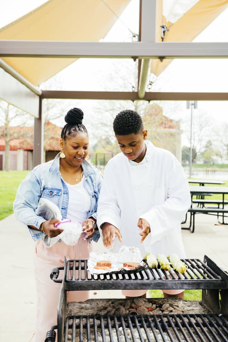 Mother and son grilling.