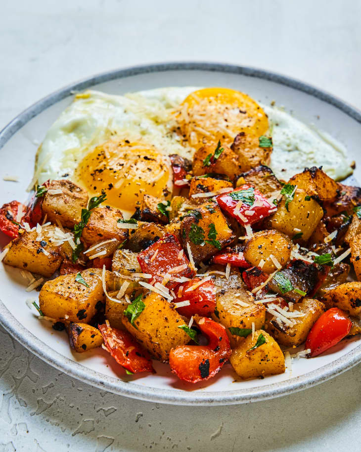 Potato Hash (diced potatoes and peppers, fried) on a plate with fried eggs.