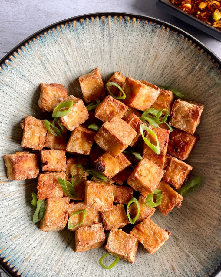 air fryer tofu in a bowl with scallion soy sauce