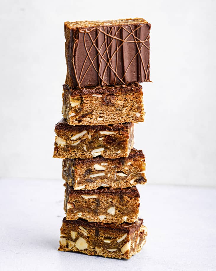 squares of Lebkuchen (a honey-sweetened German bar cookie with a gingerbread flavor) stacked, with a chocolate iced side showing in one piece