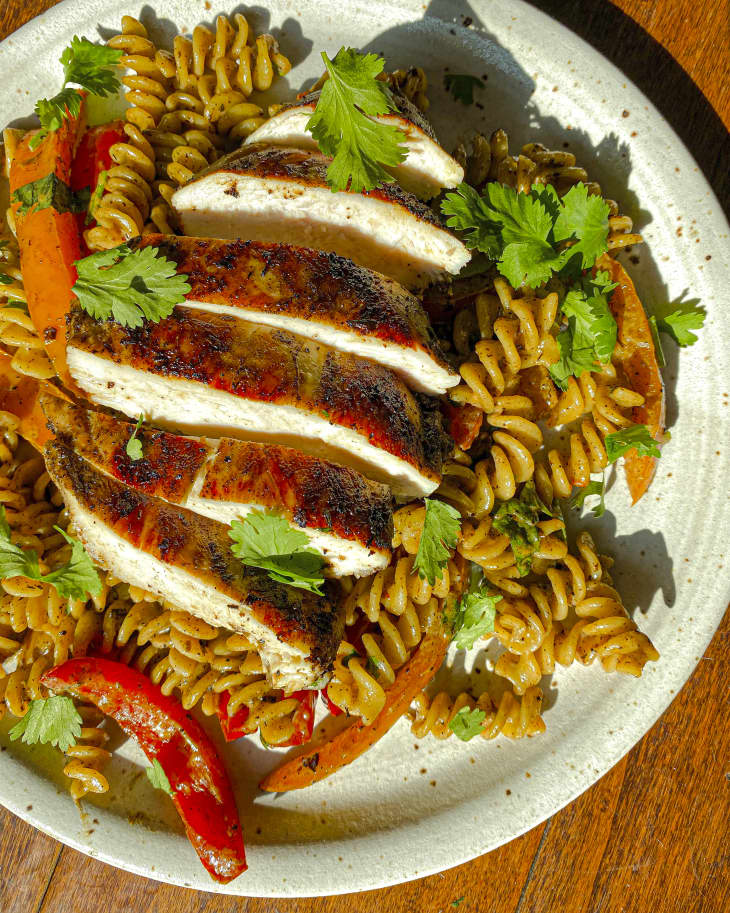 a Caribbean creamy pasta with jerk chicken sliced on top