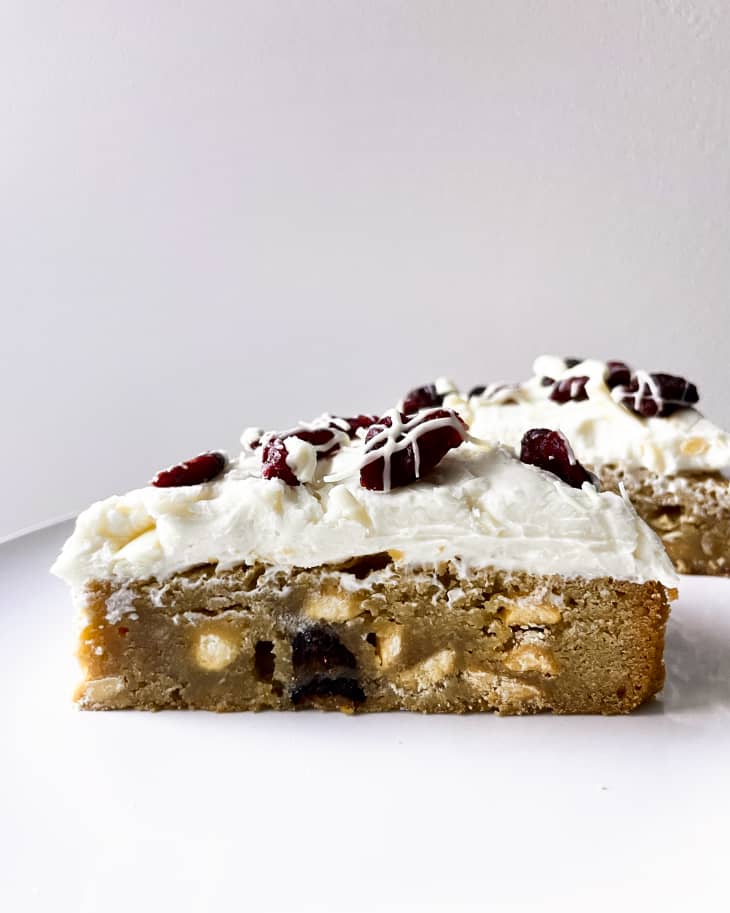 Cranberry Bliss bars (blondie cake with dried cranberries, finished with a layer of cream-cheese icing flecked with cranberries on top)