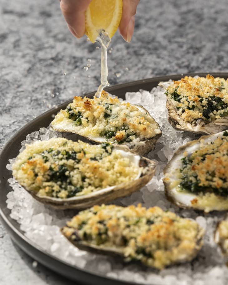 Oysters Rockefeller consists of oysters on the half-shell that have been topped with a rich sauce of butter, parsley and other green herbs, and bread crumbs, then baked or broiled.