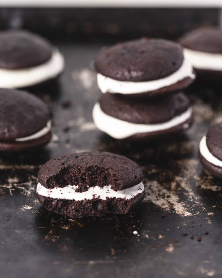 whoopie pies on  a baking tray with one with a bite taken out.