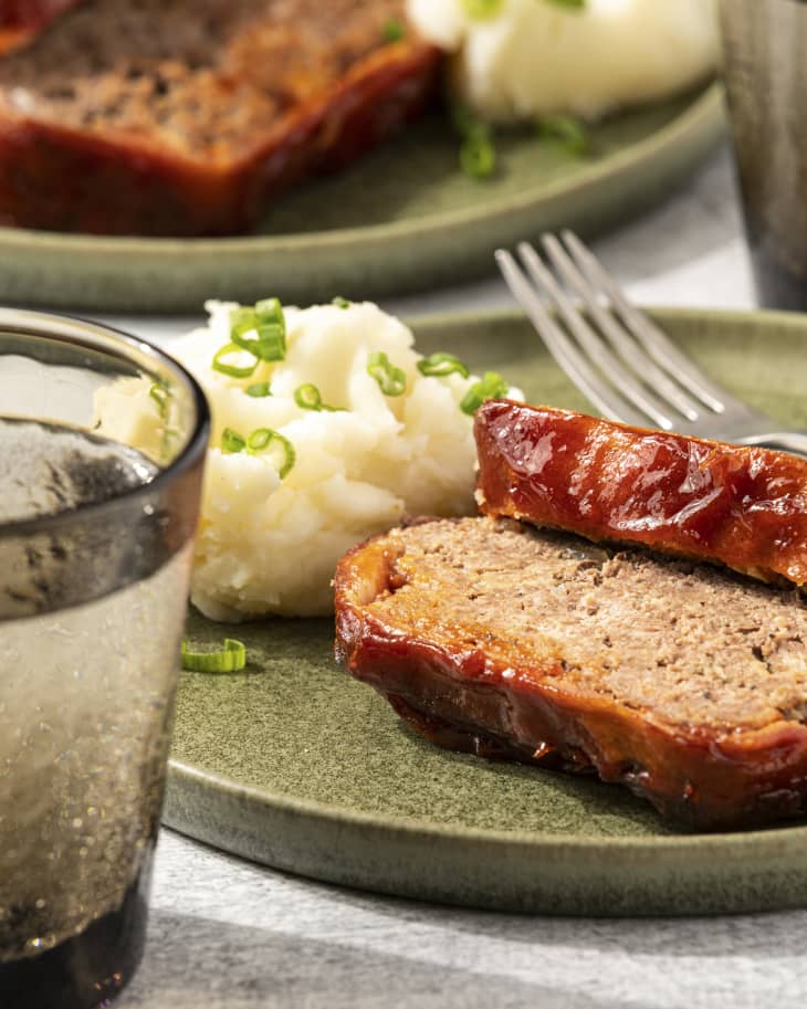 slices of meatloaf on a plate with mashed potatoes