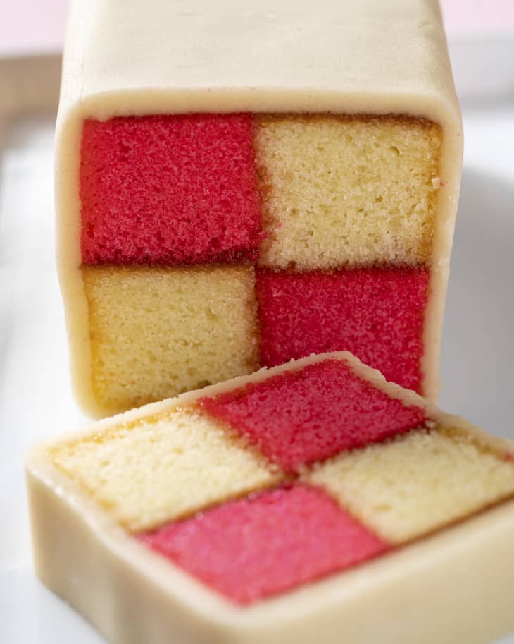 a light sponge cake with different sections held together with jam. The cake is covered in marzipan and, cut in cross section, and displays a distinctive two-by-two check pattern in red and yellow.