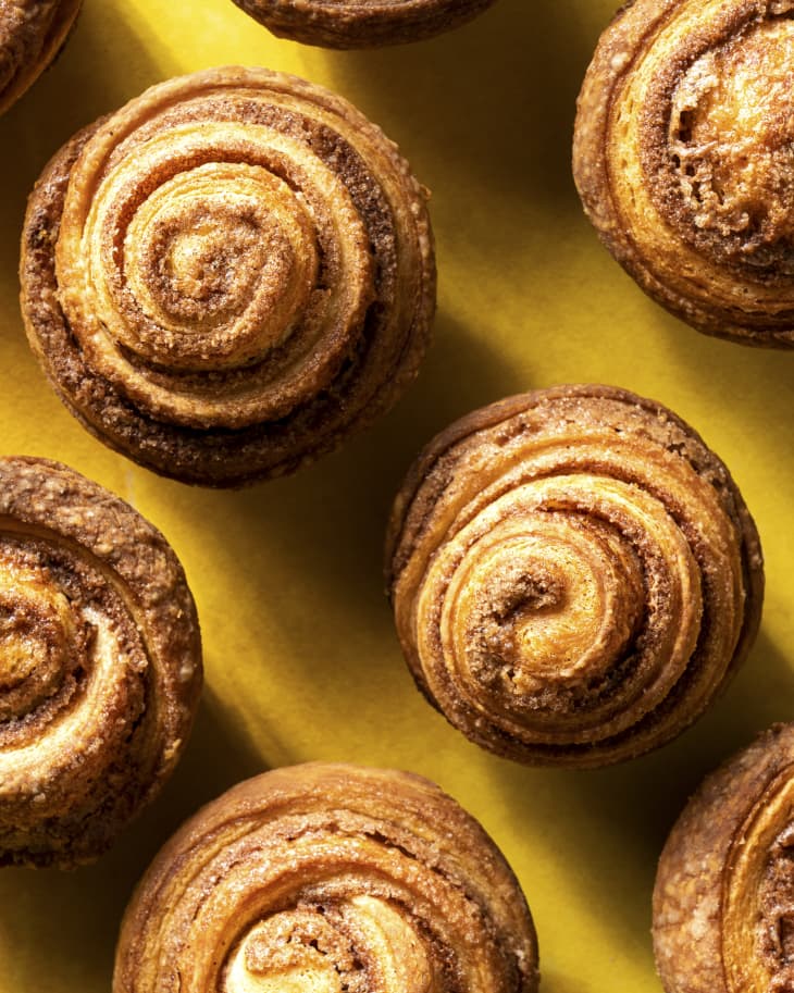 a group of browned, round, croissants in the shape of muffins (known as a cruffin) seen from the top down