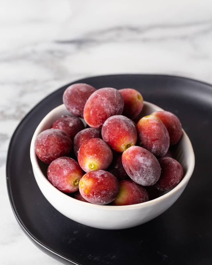 a bowl of red frozen grapes.