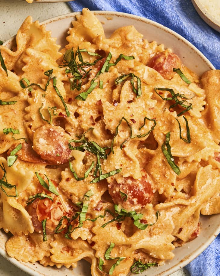 Bowtie pasta in a pink, creamy sauce, with shredded basil and tomatoes tossed it.