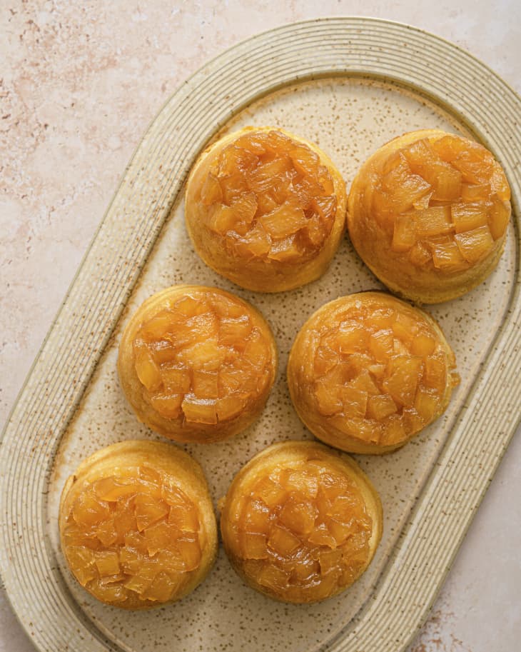 six pineapple upside down cupcakes  on an oval platter