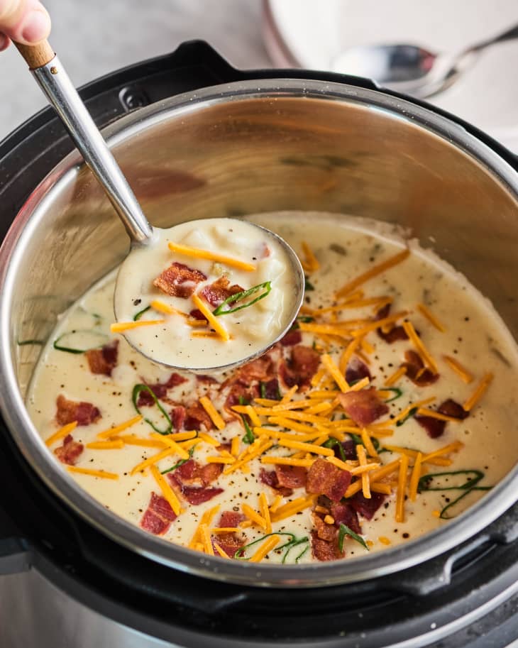 Taking a ladleful of potato soup from an Instant Pot