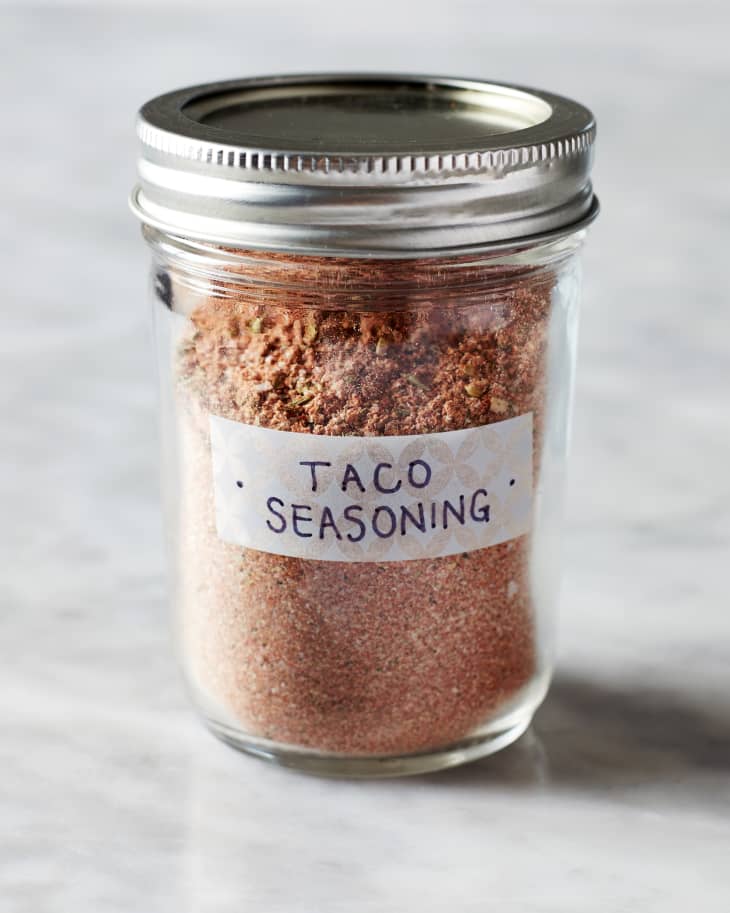 Taco seasoning in a glass mason jar with a label that says "TACO SEASONING".