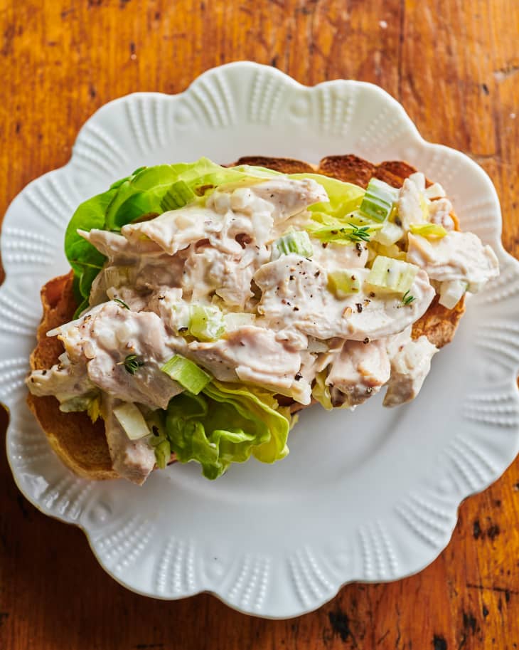Chicken salad on lettuce on a piece of toast on a plate