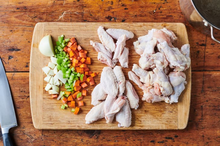 Ingredients for chicken stock laid out on a cutting board