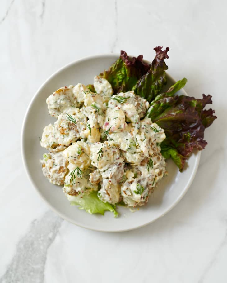 Ina Garten creamy potato salad on a bed of purple romaine lettuce