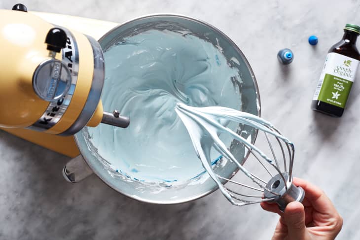 Blue royal icing in mixing bowl.