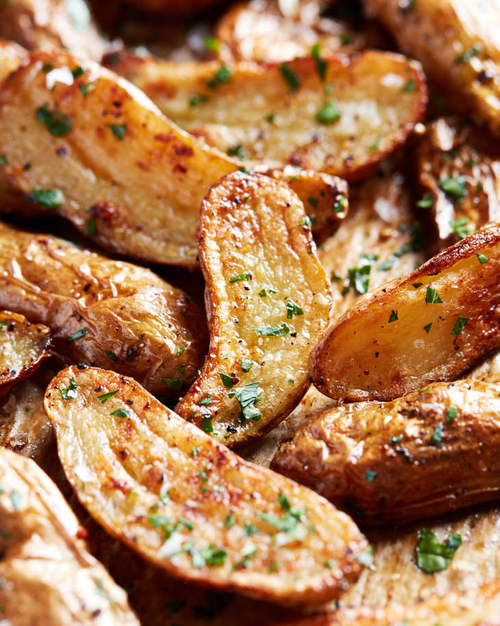 Close-up roasted fingerling potatoes garnished with thyme.