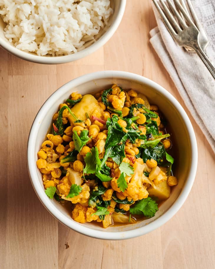 Slow cooker chick peas with vegetables Pahari Dal in bowl with fork on side.