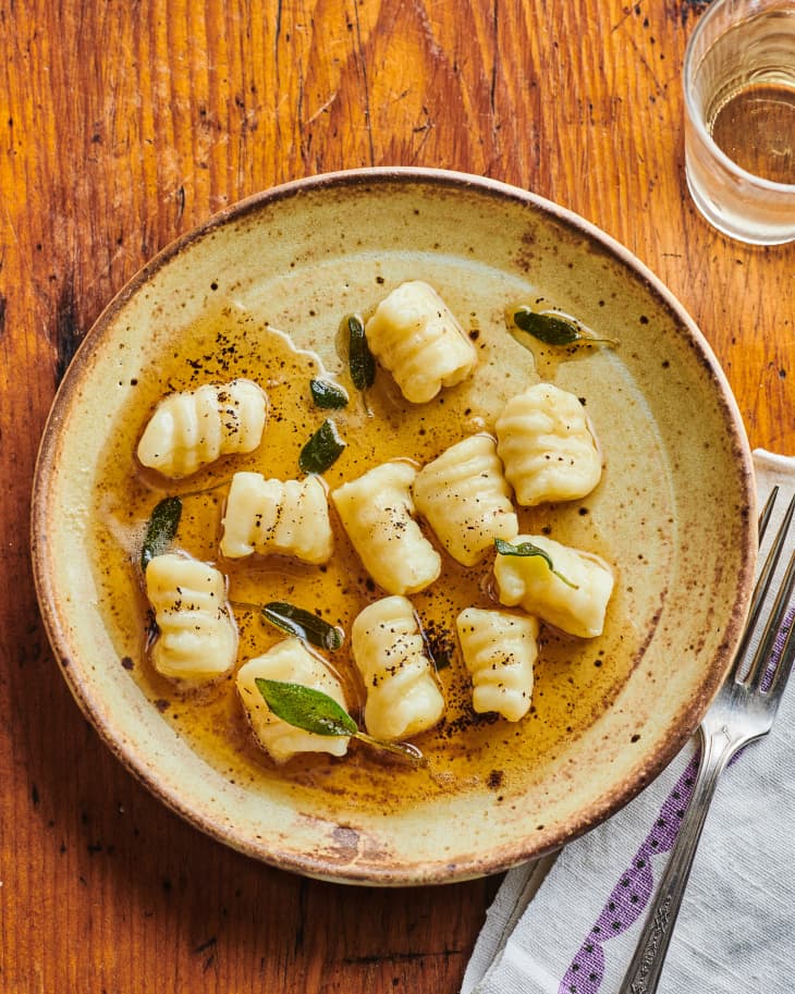 Gnocchi on plate with brown butter and sage.
