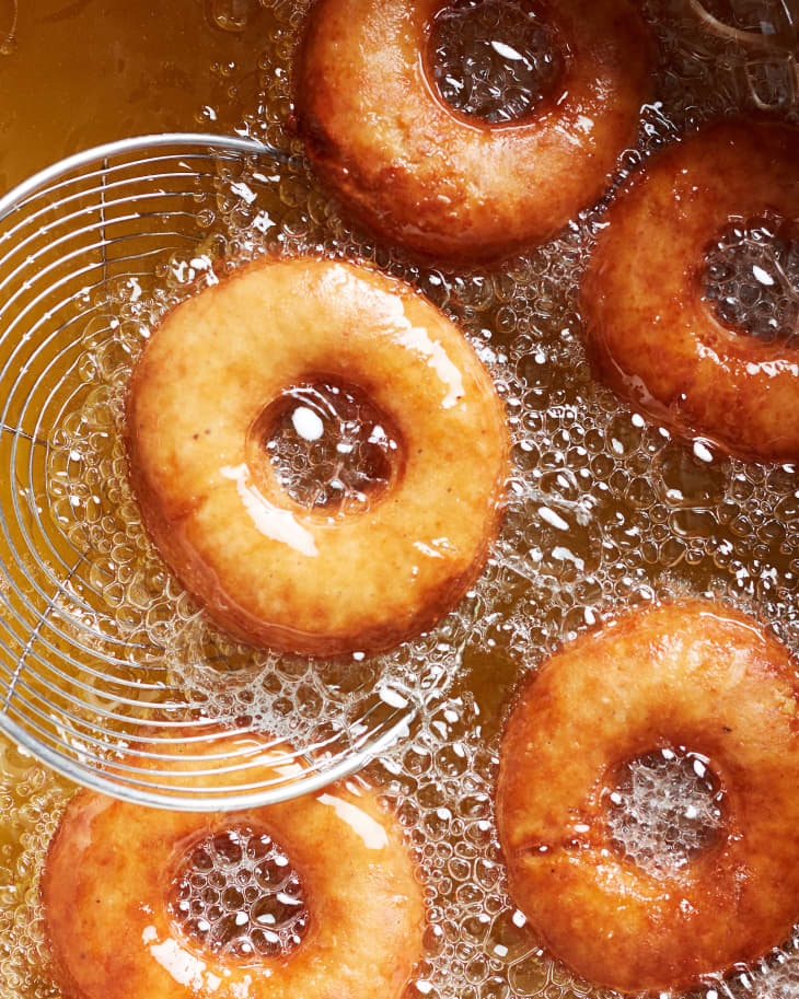 Apple cider donuts in frying oil.
