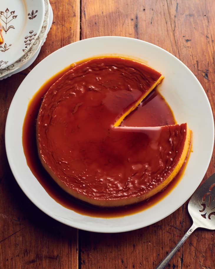 Flan on plate with slice cut out.