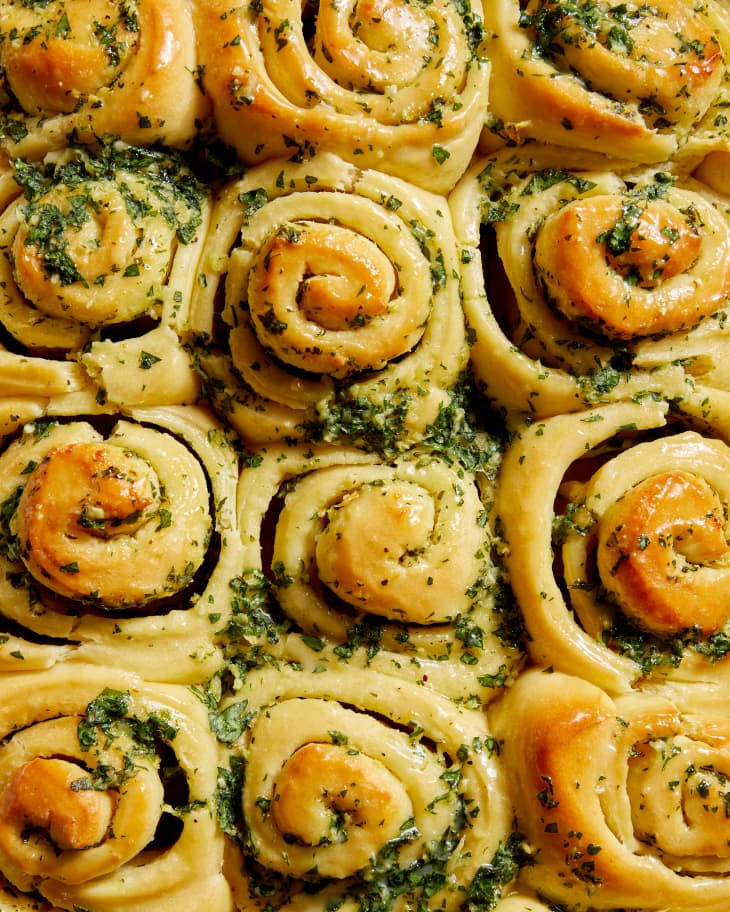 close up on garlic rolls garnished with greens