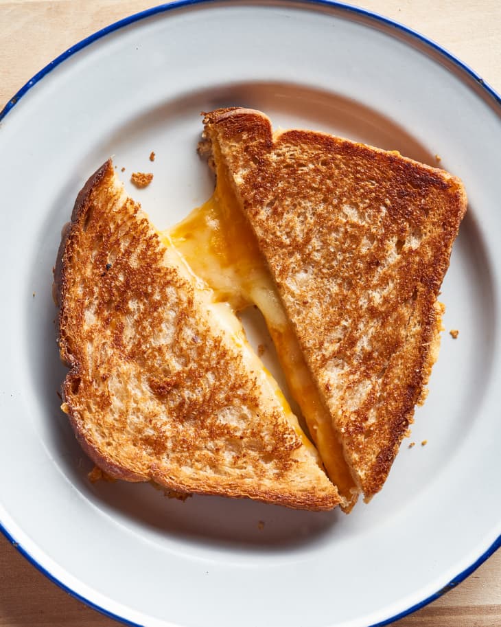 air fryer grilled cheese cut in half on a plate