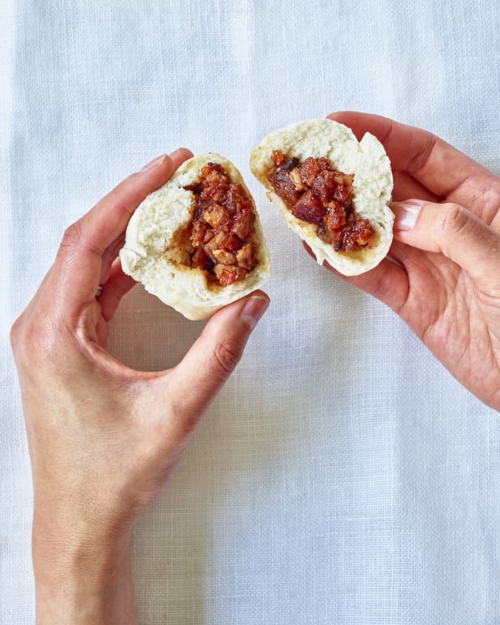 someone is pulling apart bao buns