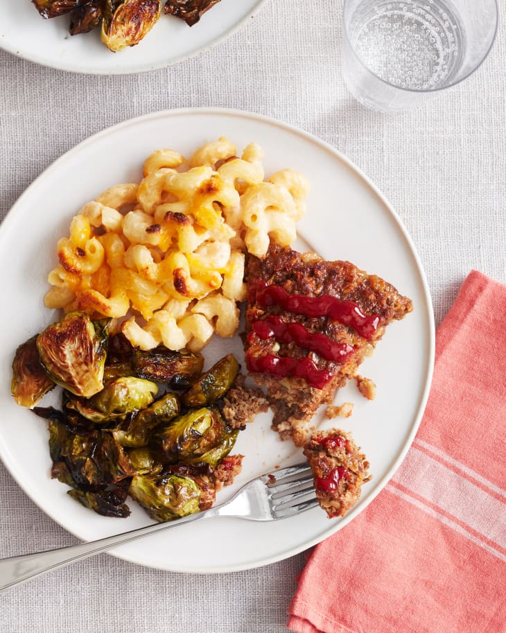 meatloaf mac and cheese on a plate with brussels sprouts