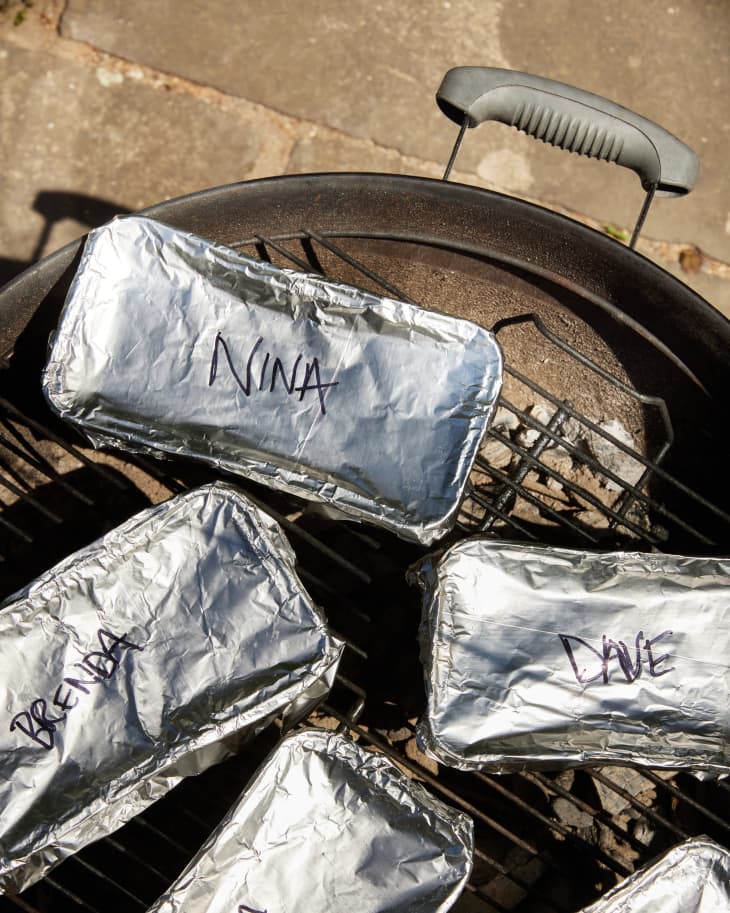 tins covered, cooking on grill