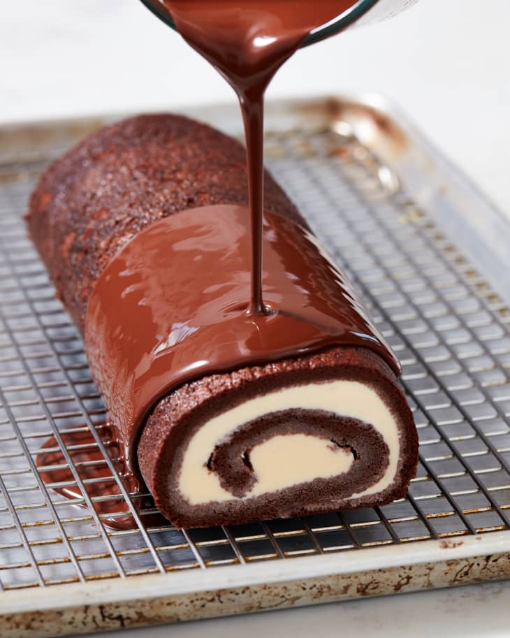 Chocolate being poured onto swiss roll