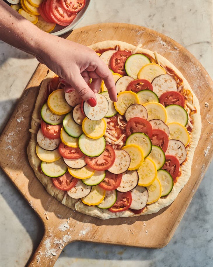 Ingredients placed on ratatouille pizza