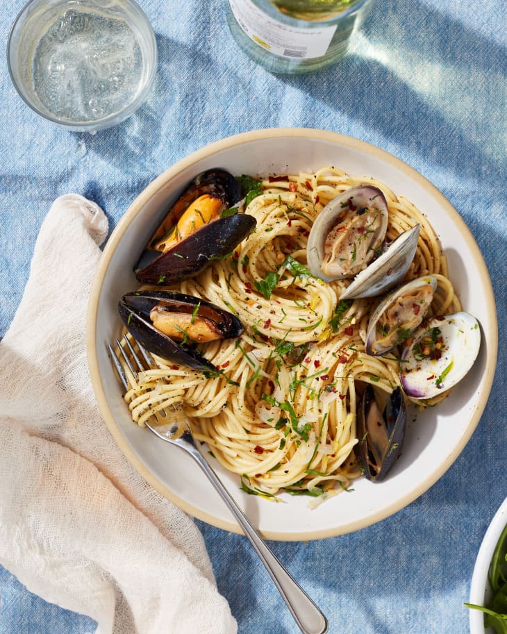 Spaghetti with mussels and clams served in bowl.