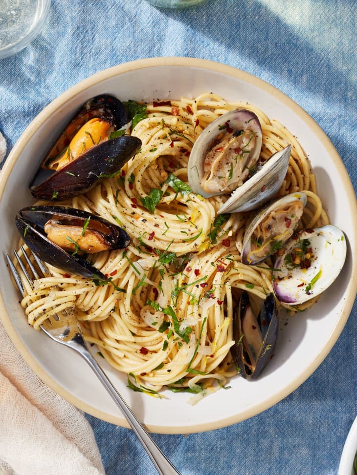 Spaghetti with mussels and clams served in bowl.