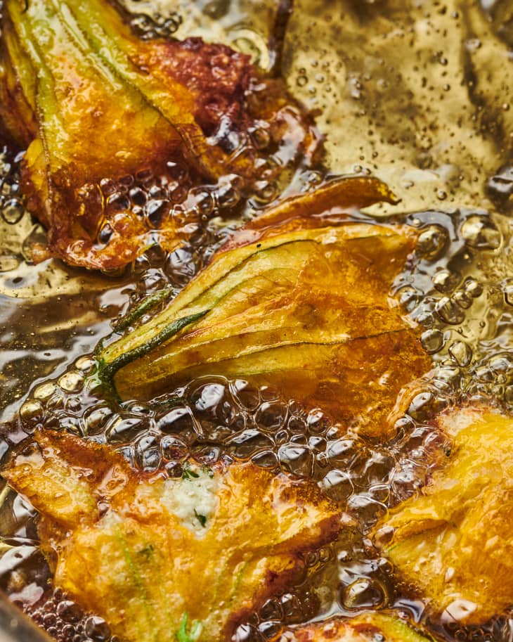 squash blossoms in fryer oil