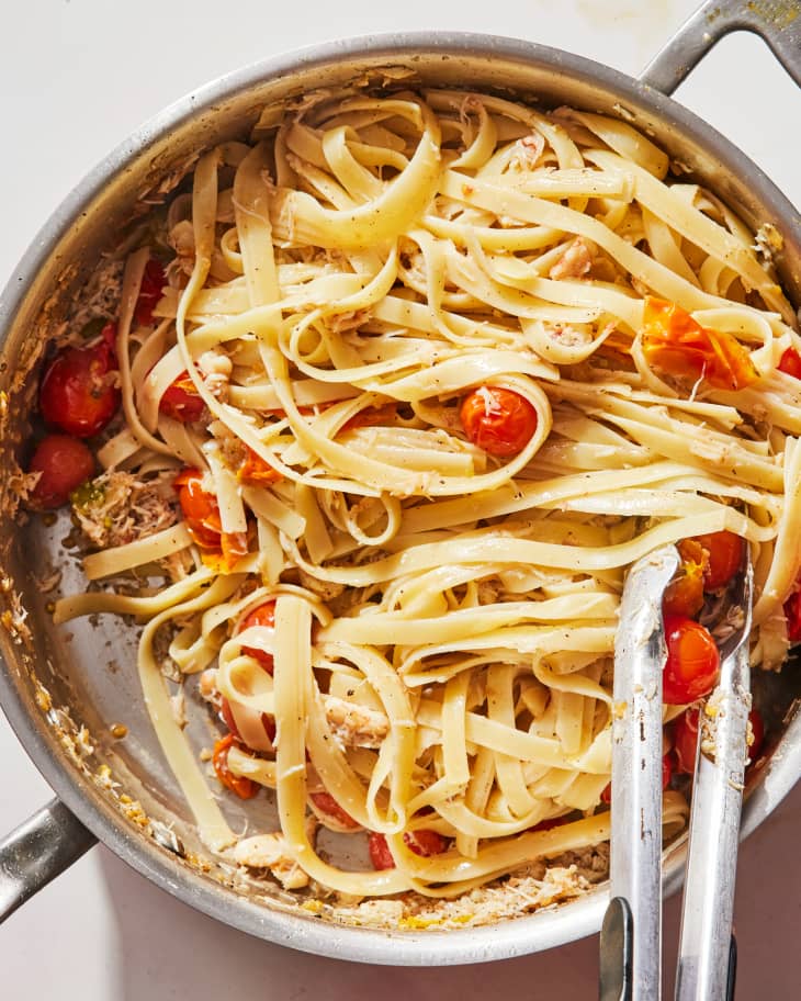 Crab pasta with brown butter and cherry tomatoes in skillet.