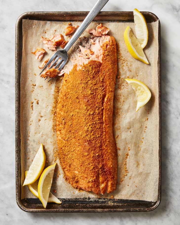 spiced salmon on parchment with fork nearby