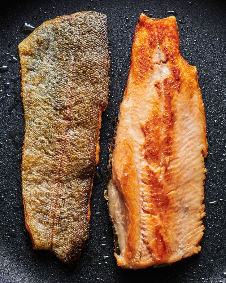 Crispy skinned seared trout in a pan