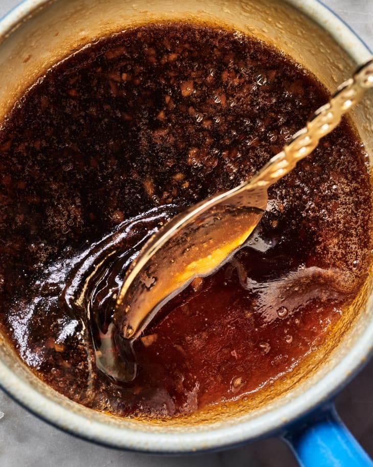 a pot of simmering fish sauce caramel being stirred