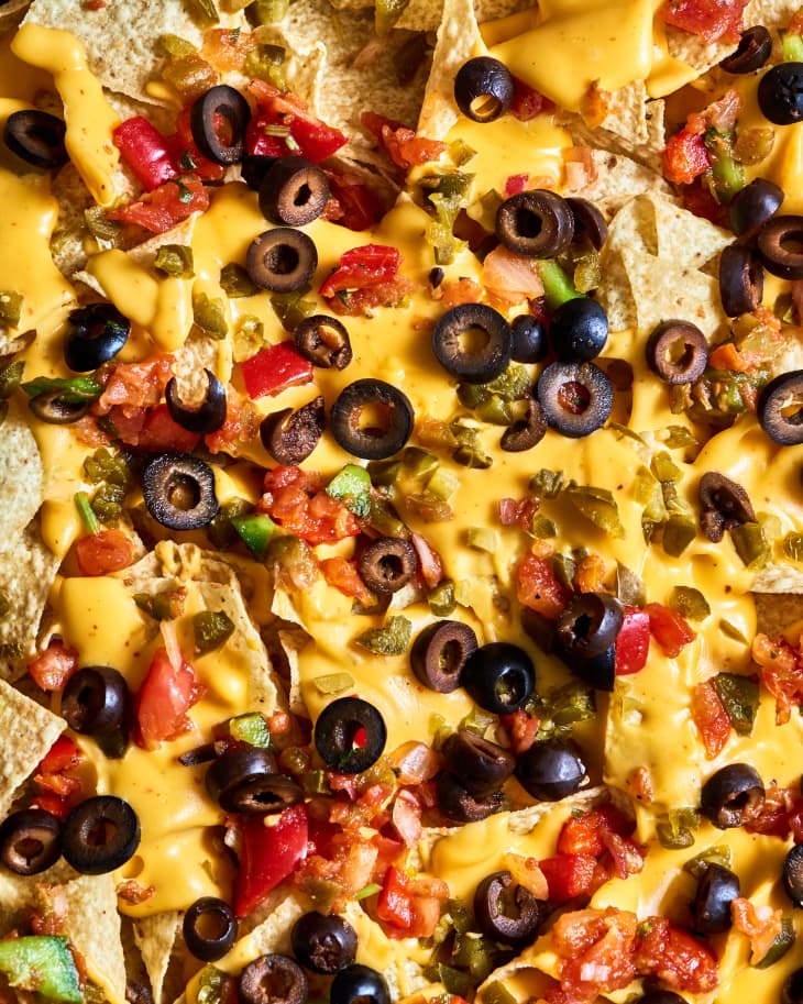 sheetpan of nachos at a table, closeup