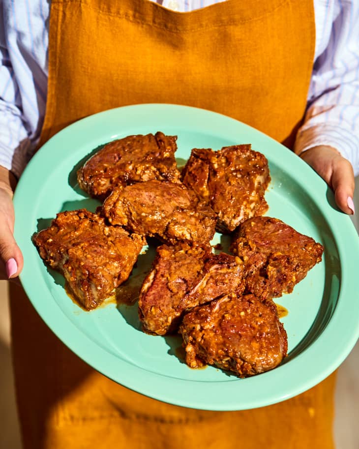 spicy sticky lamb chops being carried to the table