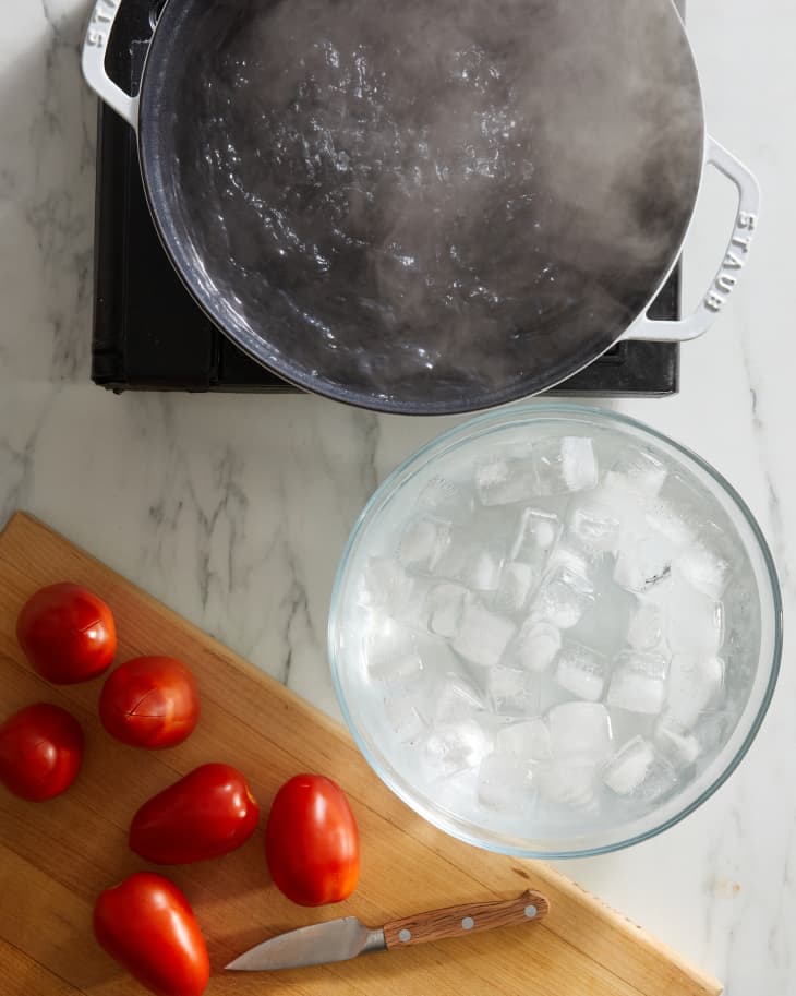 ice bath, boiling water, and tomatoes near each other
