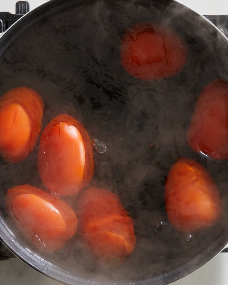 someone is boiling tomatoes