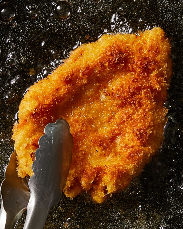 schnitzel being cooked in a pan