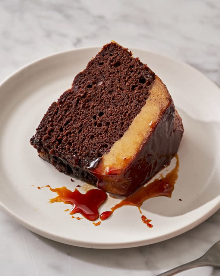 One slice of chocoflan with sauce on a plate