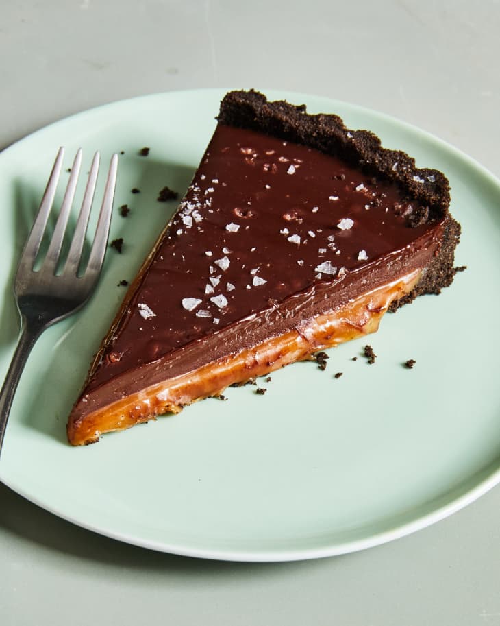 chocolate caramel tart on plate with fork