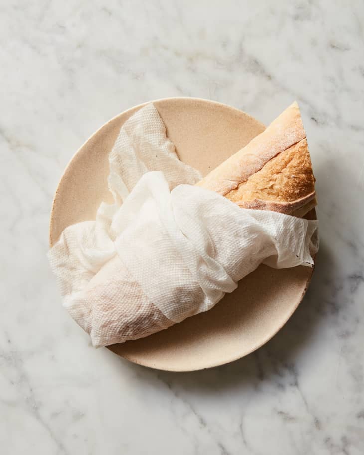 bread wrapped in paper towel on plate